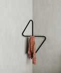 Modern wall mounted corner clothes hanger with sculptural design علاقة ملابس حائطية بتصميم هندسي عصري مثبتة في زاوية الحائط