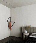 Modern wall mounted corner clothes hanger with sculptural design علاقة ملابس حائطية بتصميم هندسي عصري مثبتة في زاوية الحائط