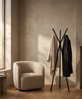 modern multipurpose cloths rack with coats and a shawl in a stylish living room setting.