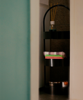 Round modern stainless steel shelving unit with multiple levels for décor and storage وحدة رفوف دائرية من ستانلس ستيل بتصميم حديث مع رفوف متعددة للديكور والتخزين