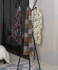 modern multipurpose cloths rack holding scarves in a chic home setting, showcasing its stylish design and functionality.